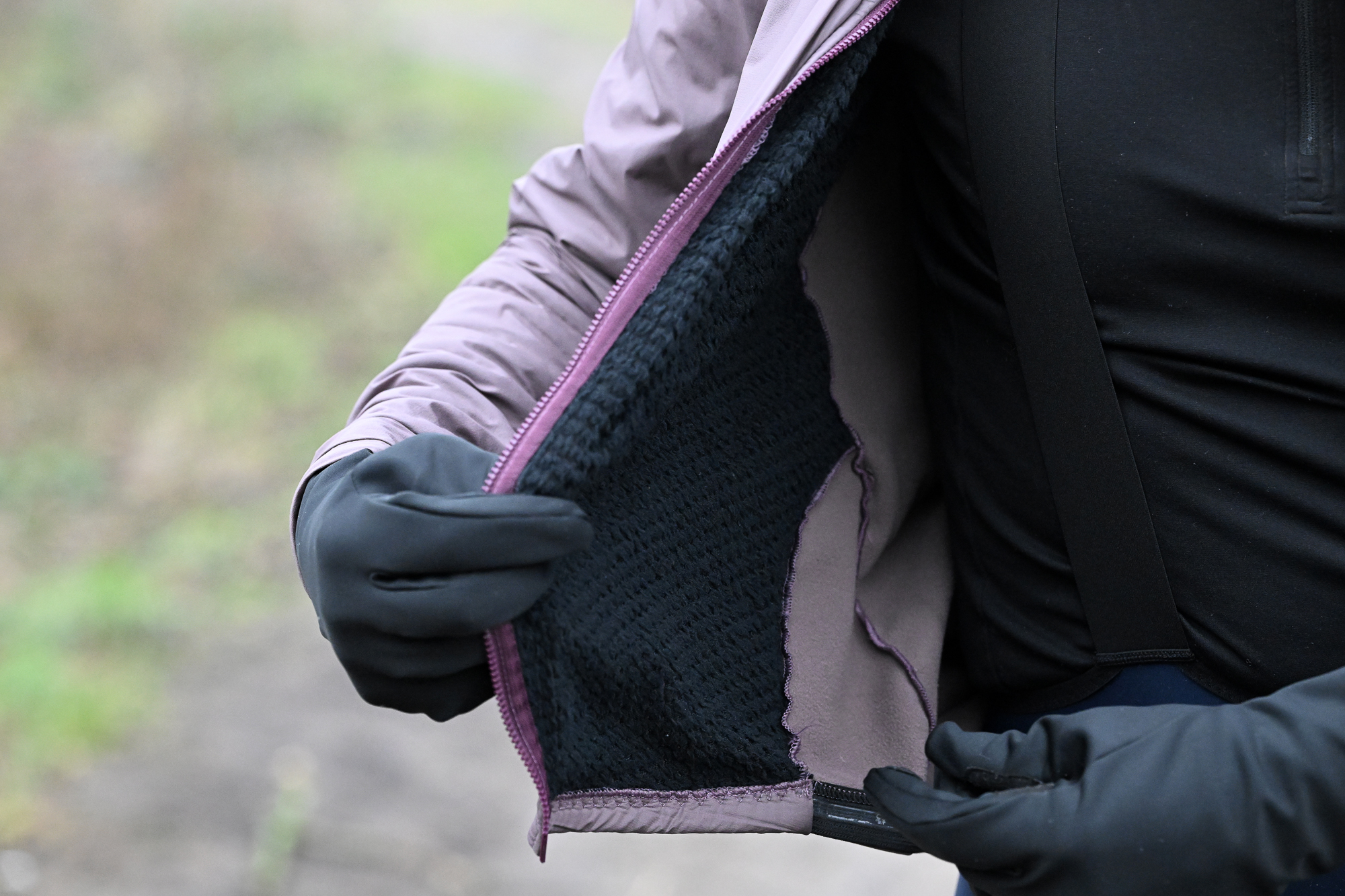 Man wearing a purple jacket, showing the fleece inside the jacket