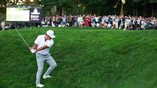 Si Woo Kim takes a shot from the 16th during the Presidents Cup