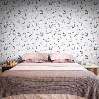 bed with side table and wallpaper on wall