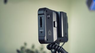Close up of the SD slot on an Atomos Shinobi on-camera monitor mounted on a Panasonic mirrorless camera