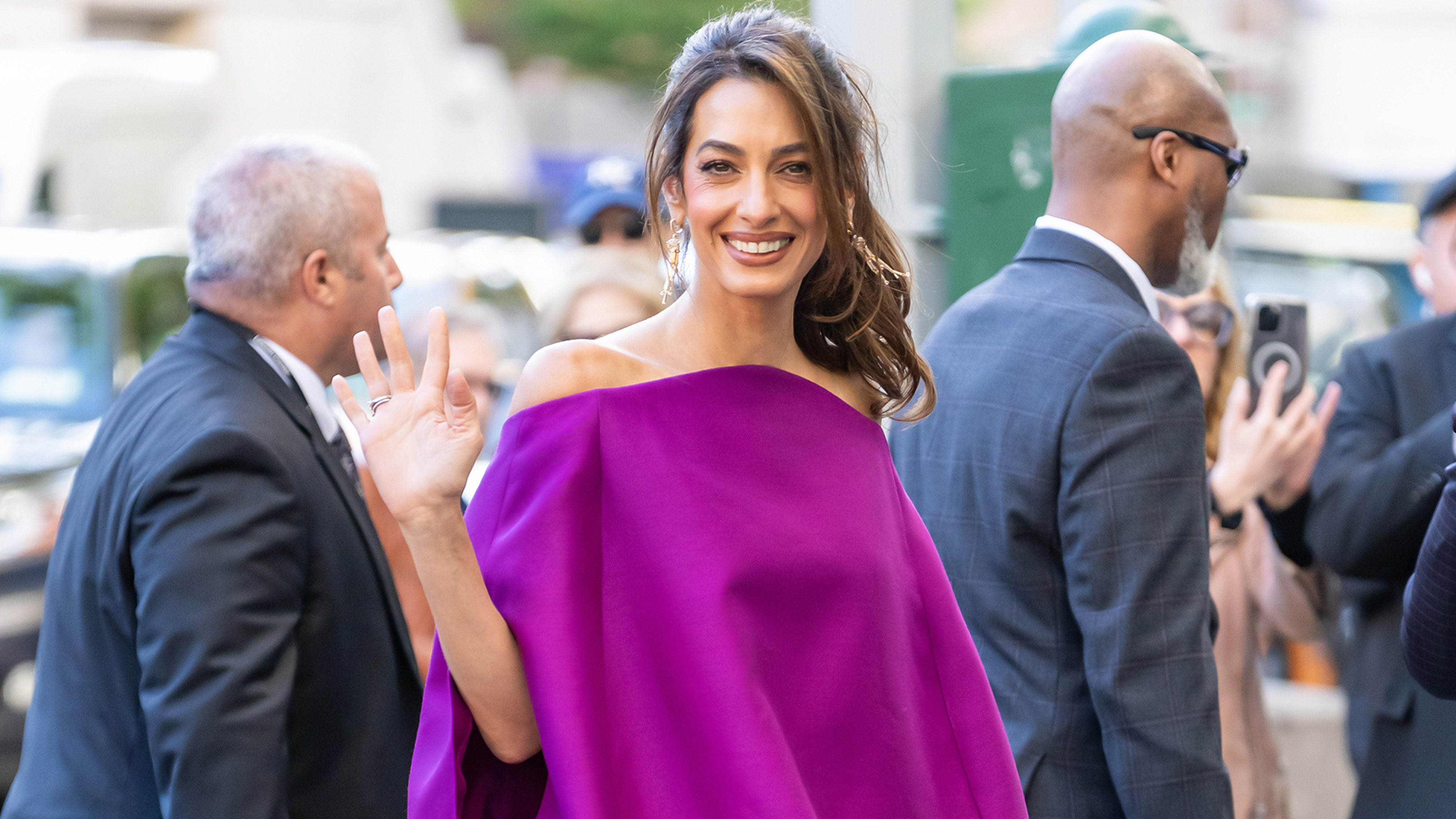 Amal Clooney wears a strapless purple minidress.