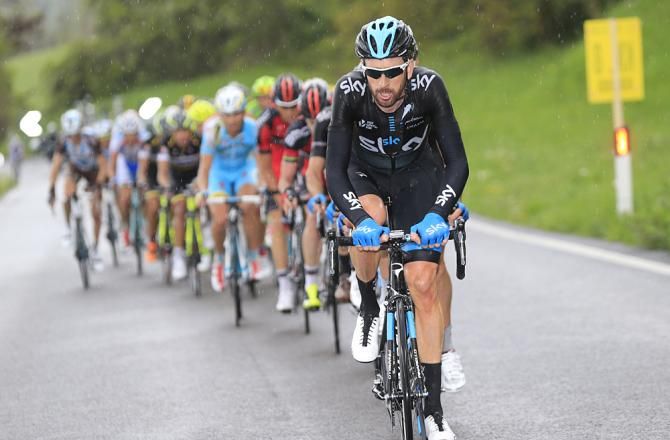Bradley Wiggins (Team Sky) leads the field through the rain during Stage 2