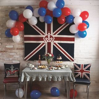 Union Jack, red white and blue ballons and table with party buffet