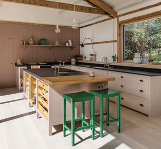 Kitchen with green stools in foreground