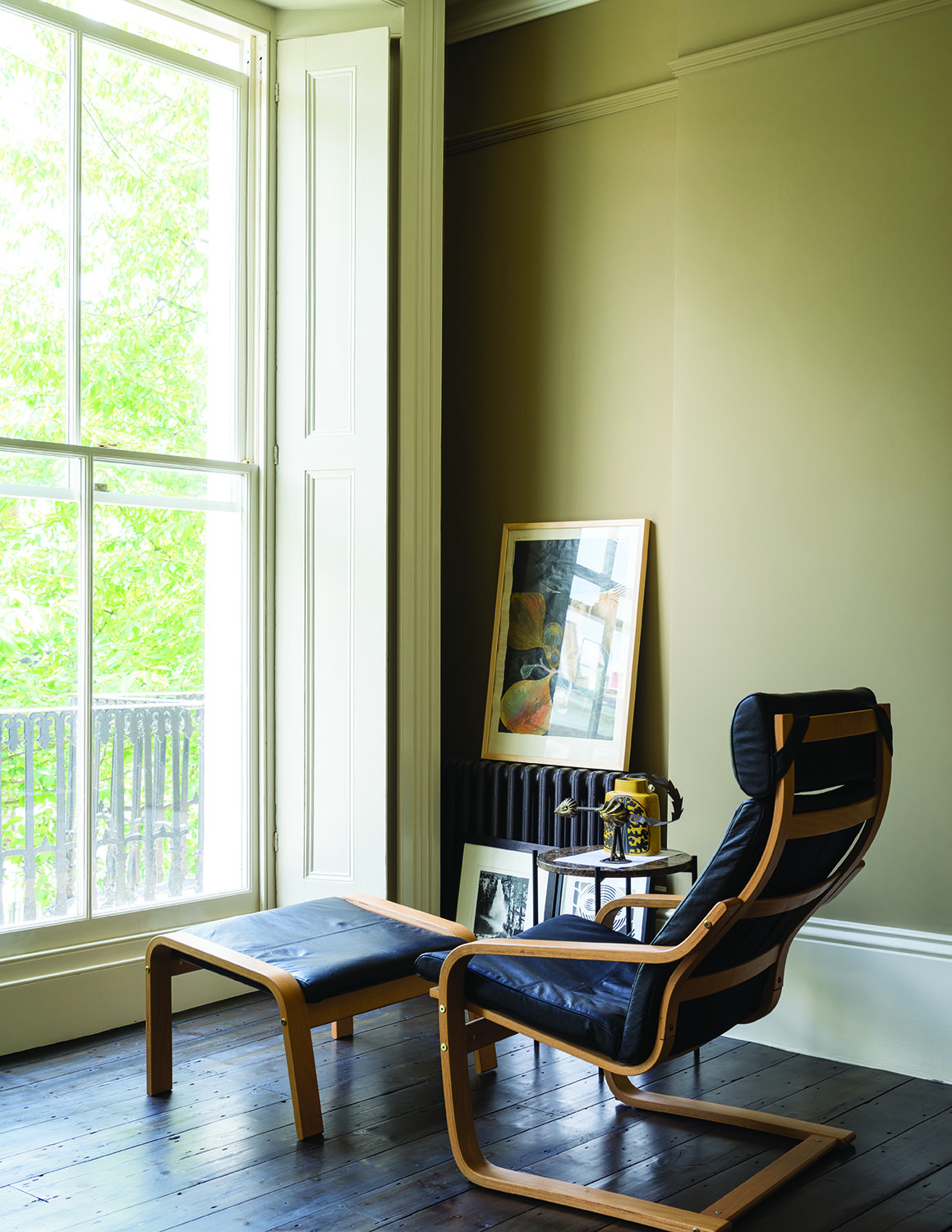 Beige living room with black leather furniture