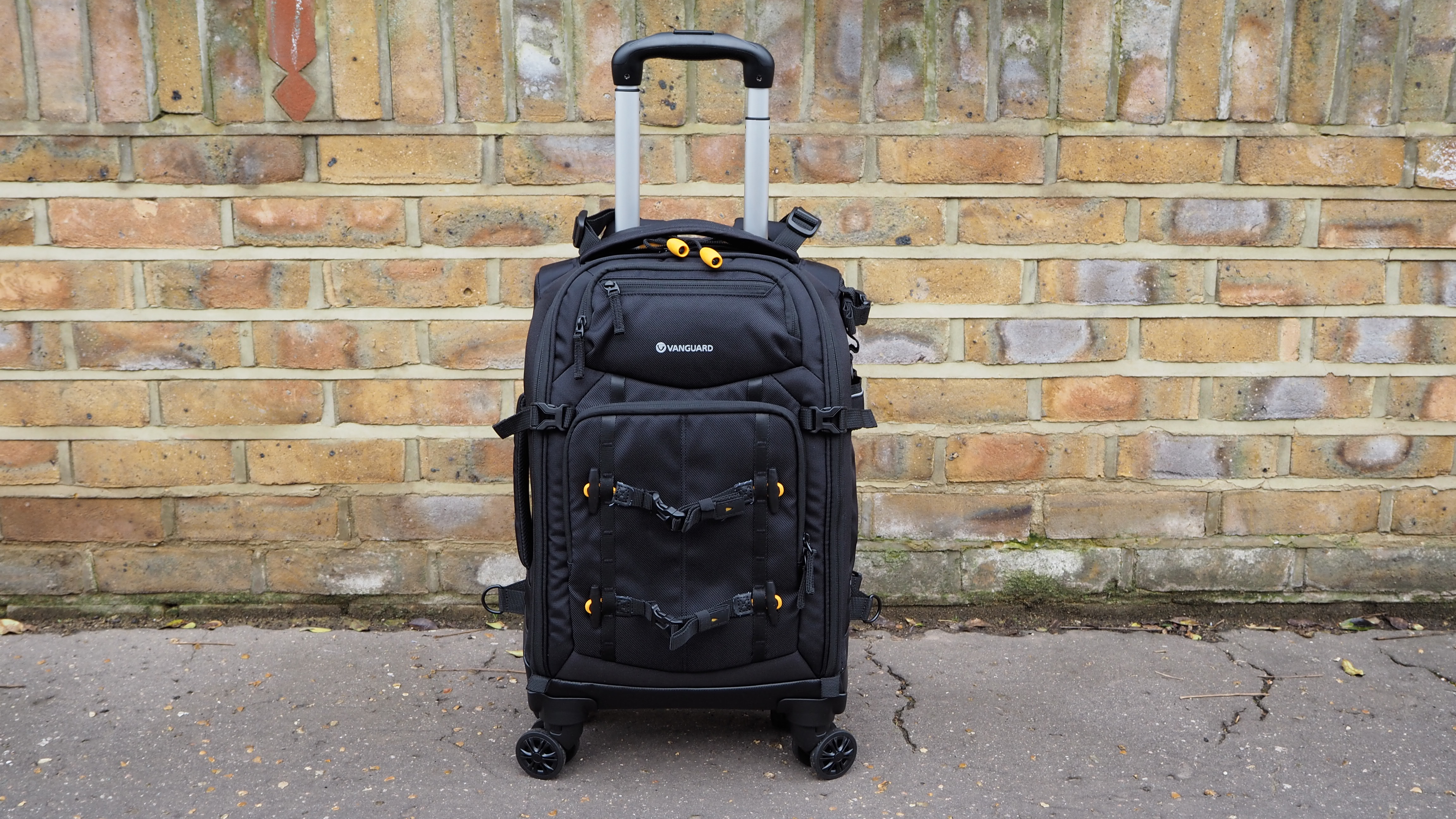 Vanguard Alta Fly 55T G2 on a street with a brick wall behind