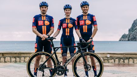 Three Picnic PostNL riders pose with their new Lapierre bike in front of the sea