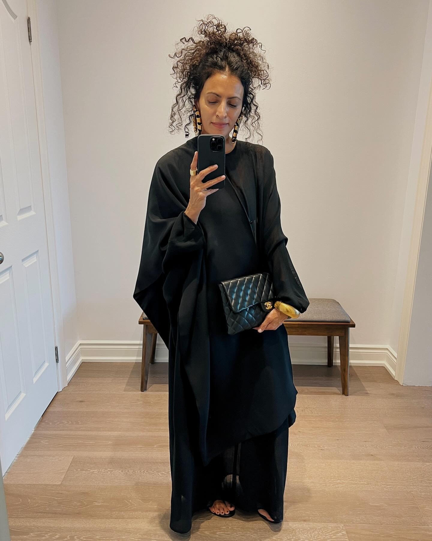 A woman wearing her hair in a curly updo.