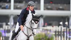 Donald Whitaker gently pats his grey horse Millfield Colette on the neck.