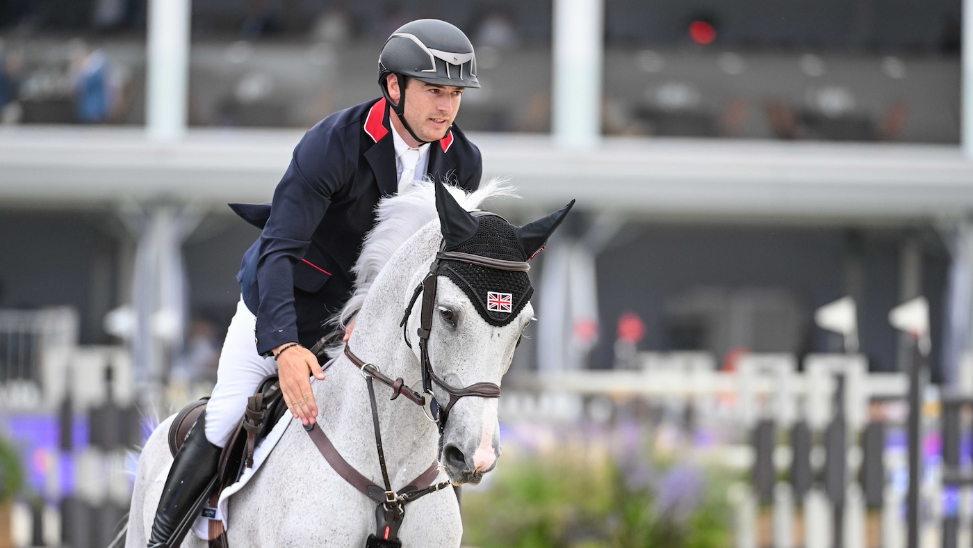 Donald Whitaker gently pats his grey horse Millfield Colette on the neck.