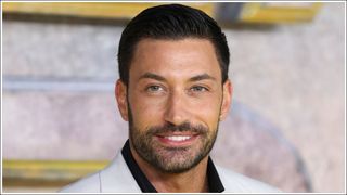 Giovanni Pernice smiling as he attends the UK Premiere of "Black Adam" at Cineworld Leicester Square on October 18, 2022 in London, England