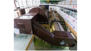 overhead view of several brown habitat buildings inside a warehouse-like structure