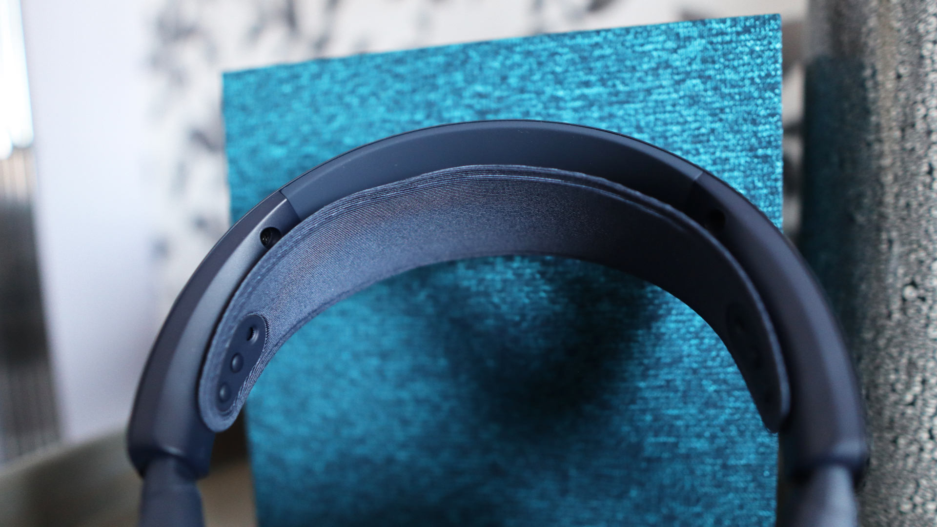 The Arctis Nova Pro Omni from SteelSeries on a desk and chair with accessories.