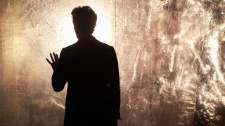 Peter Capaldi's Twelfth Doctor stands in front of the Azbantium wall in the Doctor Who episode "Heaven Sent"