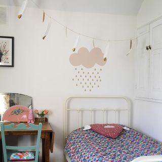 childrens room with bed and wooden table and chair