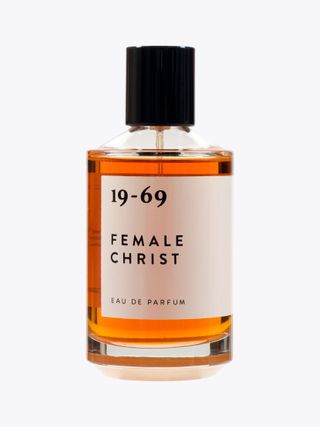 19-69 Female Christ fragrance in clear bottle against grey background