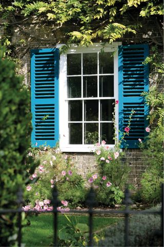 Sash window with blue shutters