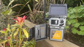 Spypoint Link-Micro-S-LTE trail camera resting in the garden with solar panel and antenna