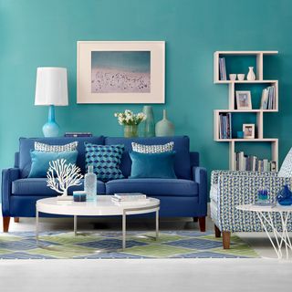 living room with blue sofa and lamp