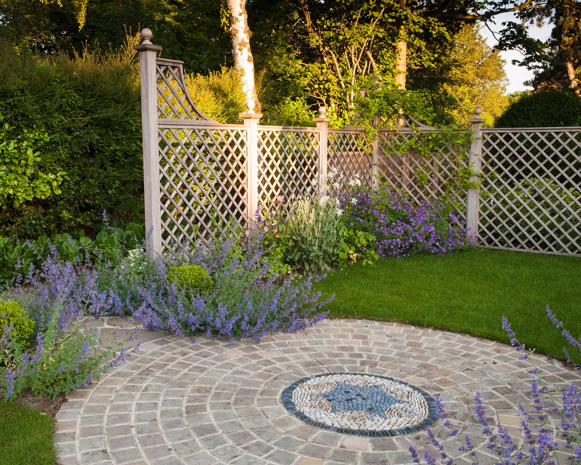 patio with stone mosaic and trellis