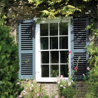 white and blue shutters and sash window