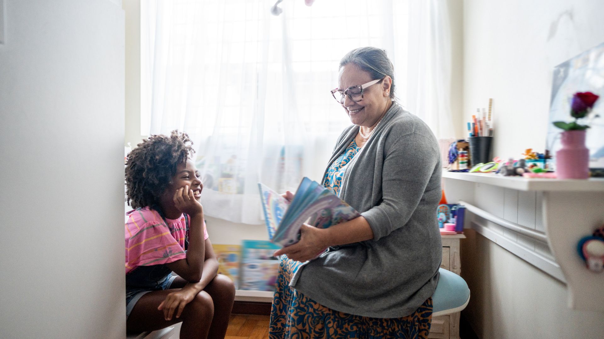 Mature woman reading a book to her foster child
