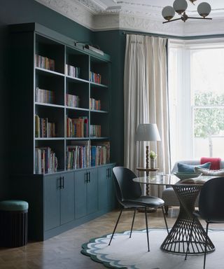 Library with blue bookcases in Victorian living room