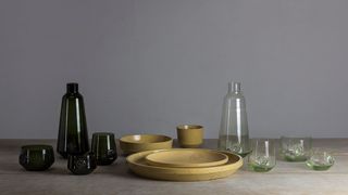 A collection of glasses, plates and vases made from glass