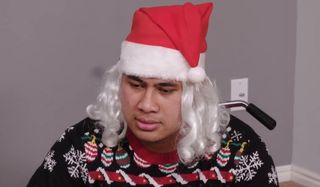 Asuelu looking sad in a santa hat 90 Day Fiance: Happily Ever After? TLC