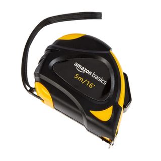 Black tape measure with yellow corners and Amazon branding