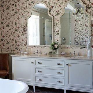 bathroom with wallpaper on wall and drawers
