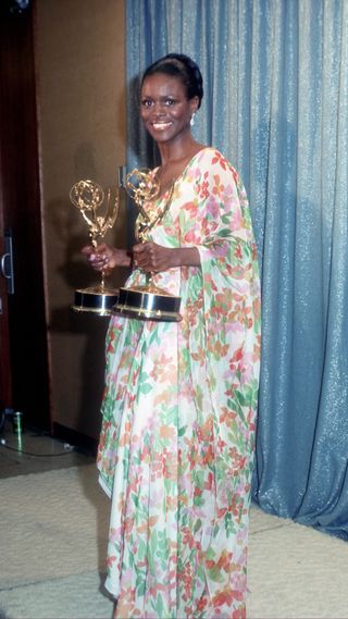 Cicely Tyson in a floral gown collecting two Emmy awards