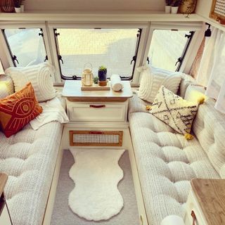 caravan interior with white sofas