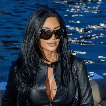 Kim Kardashian wears a two-piece leather Gucci racing suit and carries a matching Gucci bag to support boyfriend Lewis Hamilton at the Monaco Grand Prix
