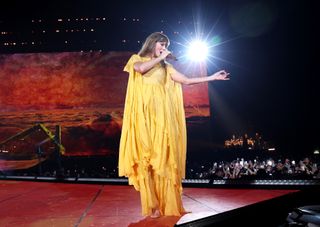 Taylor Swift performs at the Eras tour in Paris in a yellow alberta ferretti dress