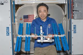 Japanese astronaut Satoshi Furukawa poses with the LEGO model of the International Space Station that he built on board the real space station. 