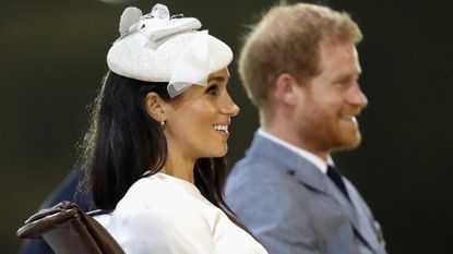 Prince Harry and Meghan Markle, seated and in profile