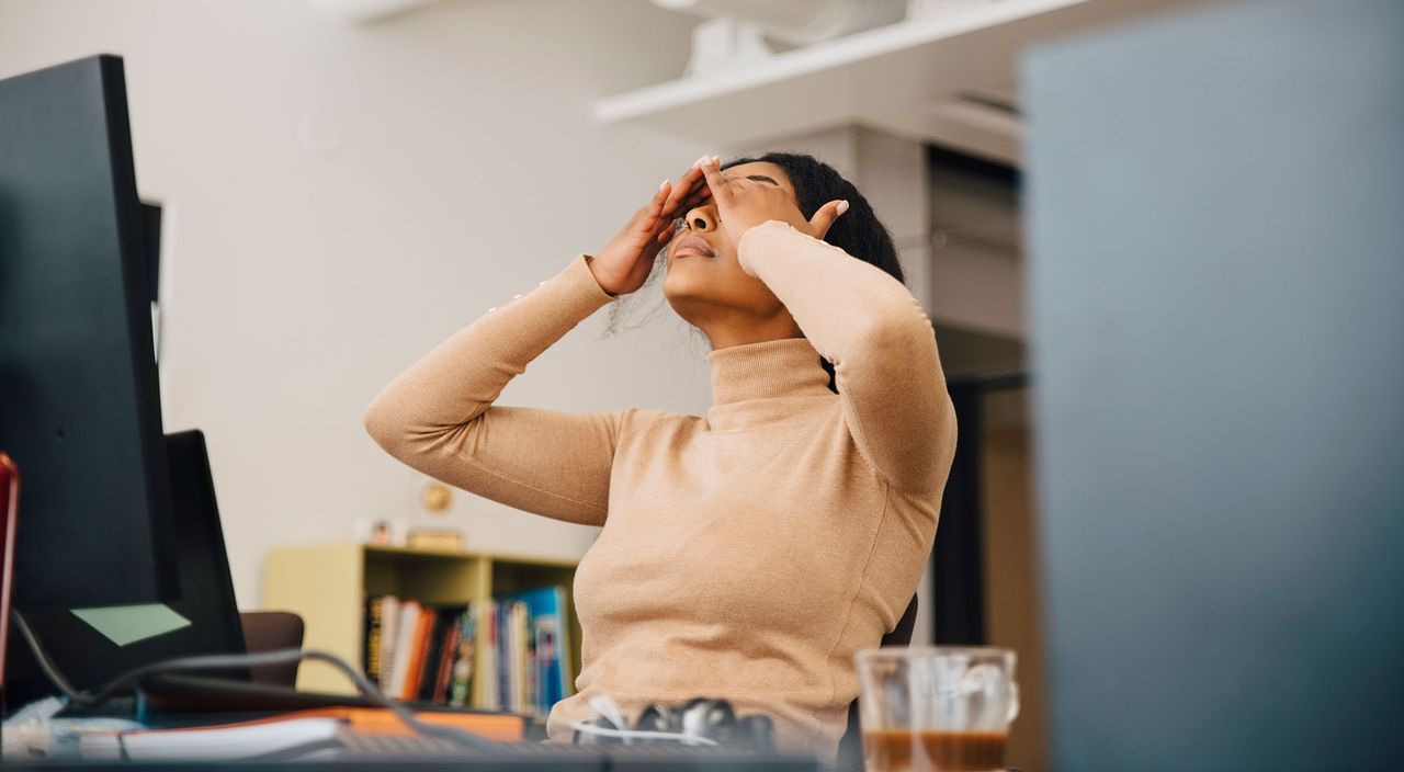 Stressed woman working in a toxic workplace