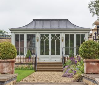 traditional garden room with metal roof and window details