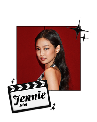 Jennie Kim poses in front of a red wall