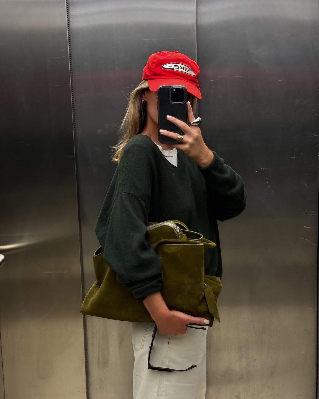 @tinvcb wears khaki jumper and bag