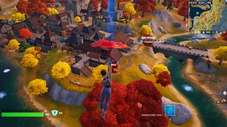 Fortnite - a player parachutes down to a marked house near Anvil Square