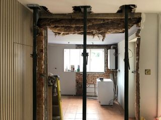 accrows supporting a knocked down internal wall