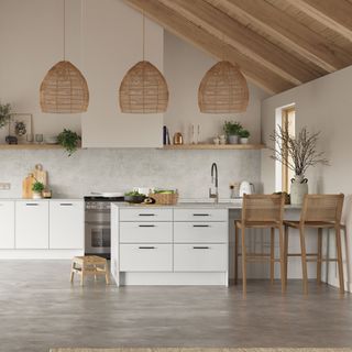 white kitchen with natural materials and three oversized pendant lights