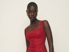 a model wears a red sleeveless dress by Reformation