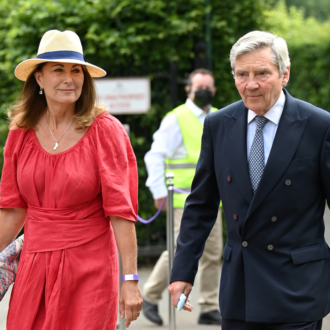 Princess Kate's mom Carole Middleton wears a bright red dress and a sun hat to attend Wimbledon Tennis Championships with husband Michael Middleton on July 09, 2021 in London, England
