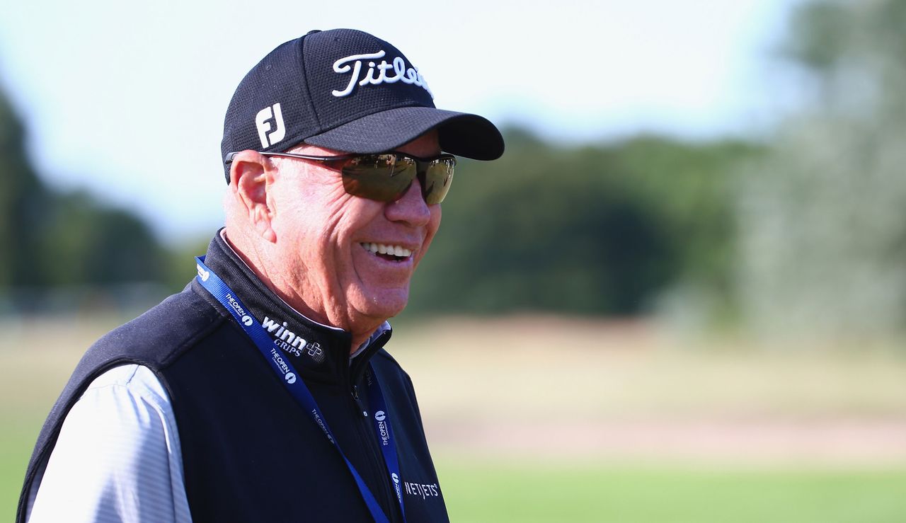 Harmon smiles whilst wearing an Open Championship lanyard 