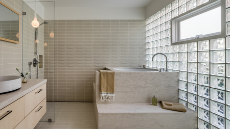 A soothing bathroom design with a full glass block wall