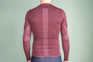 A man wearing the Van Rysel Long Sleeve Racer 2 base layer