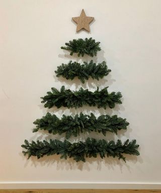 Wall mounted Christmas tree on white Wass with wooden star